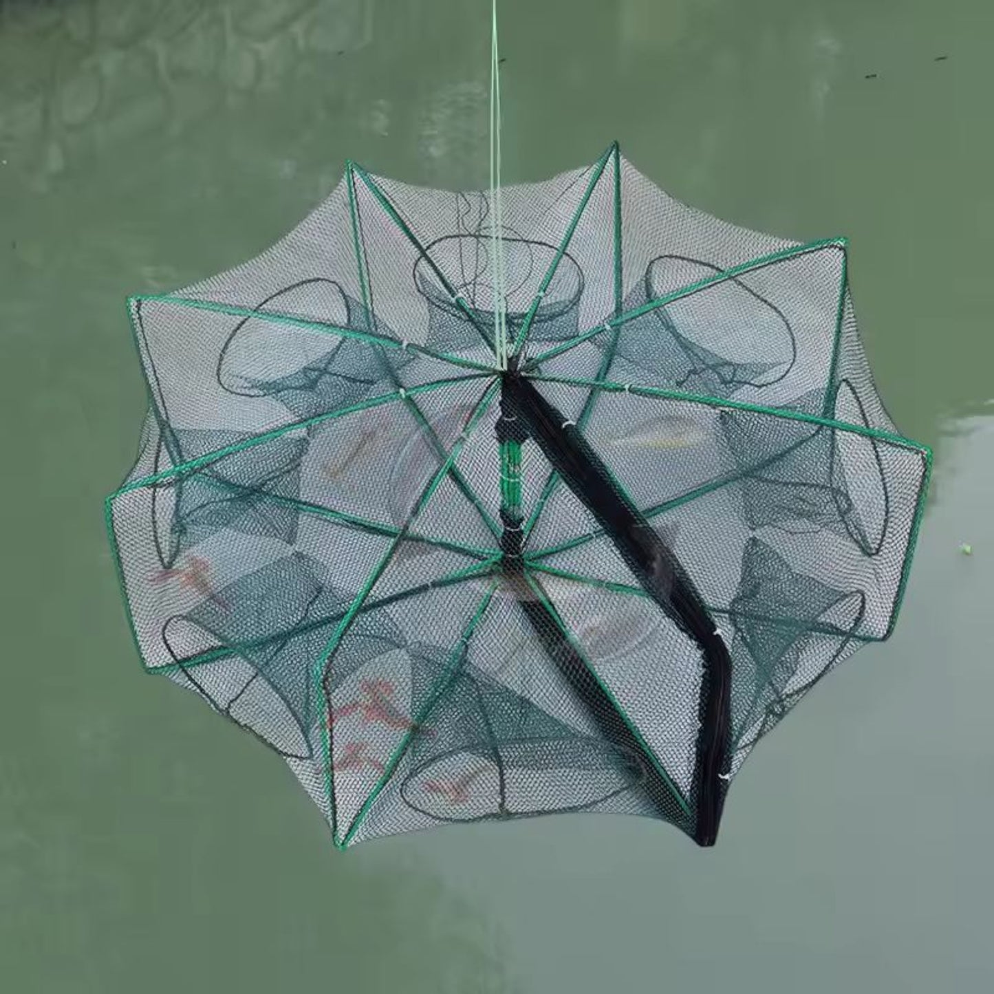 Person holding the folded fishing trap net by its top handle, demonstrating its lightweight and portable design for easy carrying."