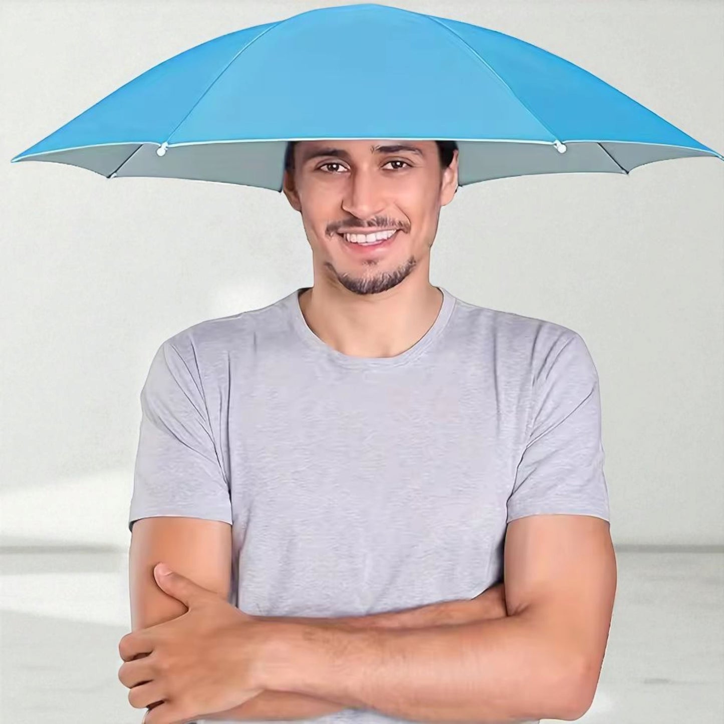 Man wearing a blue hands-free umbrella hat for sun and rain protection