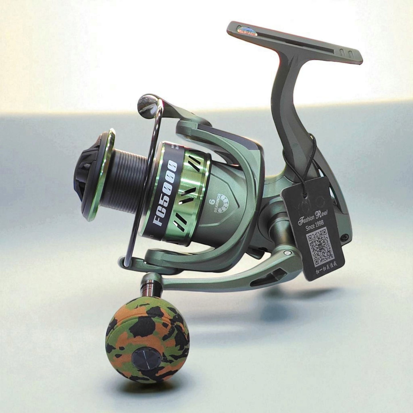 FC5000 heavy duty spinning fishing reel in military green with camouflage EVA grip, designed for big catch performance in fresh and saltwater fishing